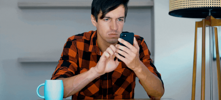 mobile-seo-website-design-business-marketing-frustrated man in red plaid frustrated with slow phone. Angry.